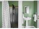 Quaint bathroom featuring a pedestal sink and a walk-in shower with corrugated metal at 286 Mallard Lake Rd, Dorchester, SC 29437