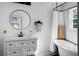 Modern bathroom featuring white cabinets, round mirror, and a separate tub with shower at 286 Mallard Lake Rd, Dorchester, SC 29437