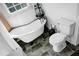 Clean bathroom featuring a clawfoot tub, a modern toilet, and sleek black and gray tile flooring at 286 Mallard Lake Rd, Dorchester, SC 29437