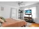 Spacious bedroom with ceiling fan, natural light, and a large television at 286 Mallard Lake Rd, Dorchester, SC 29437