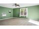 Bright bedroom with tile floors, green walls, a ceiling fan, and large windows at 286 Mallard Lake Rd, Dorchester, SC 29437