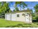 Exterior of the three-door garage, including a Personal door, on a large green lawn with a metal roof at 286 Mallard Lake Rd, Dorchester, SC 29437