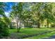 Charming exterior view of a well-maintained home with lush green lawn and mature trees offering privacy and shade at 286 Mallard Lake Rd, Dorchester, SC 29437