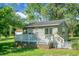 Charming cottage with back deck, white railing, and mature trees at 286 Mallard Lake Rd, Dorchester, SC 29437