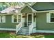 Charming home featuring a welcoming front entrance with hanging flower baskets and a cozy chair on the porch at 286 Mallard Lake Rd, Dorchester, SC 29437
