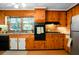 Classic kitchen with wooden cabinets, stone countertops, updated appliances, and linoleum flooring at 286 Mallard Lake Rd, Dorchester, SC 29437