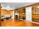 Spacious living room featuring a fireplace, wood-paneled walls, hardwood flooring, and modern neutral decor at 286 Mallard Lake Rd, Dorchester, SC 29437