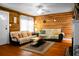 Comfortable living room showcasing hardwood floors, wood paneling, fireplace and neutral furniture at 286 Mallard Lake Rd, Dorchester, SC 29437