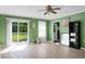Cozy living room with tile floors, green walls, access to the back deck, and a ceiling fan at 286 Mallard Lake Rd, Dorchester, SC 29437