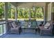Cozy screened porch featuring wicker furniture and wooded views at 286 Mallard Lake Rd, Dorchester, SC 29437