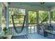 Relaxing screened porch with a hanging hammock chair and ceiling fan at 286 Mallard Lake Rd, Dorchester, SC 29437