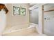 Relaxing bathroom showcasing a luxurious soaking tub, a separate shower, and a decorative window at 2938 Old Drake Dr, Seabrook Island, SC 29455