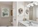 Elegant bathroom with white vanity, marble countertop, stylish mirror, and a view of the outdoors at 2938 Old Drake Dr, Seabrook Island, SC 29455