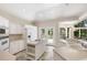 Well-lit kitchen with an island cooktop, white cabinetry, and a door to the outdoor space at 2938 Old Drake Dr, Seabrook Island, SC 29455