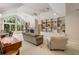 This living room features a cozy fireplace, high ceilings, large windows, and built-in shelving for storage at 2938 Old Drake Dr, Seabrook Island, SC 29455