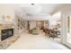 Spacious living room with a fireplace, built-in shelving, and access to multiple rooms at 2938 Old Drake Dr, Seabrook Island, SC 29455