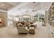 Bright and spacious living room with high ceilings, large windows, and an open layout connecting to the kitchen at 2938 Old Drake Dr, Seabrook Island, SC 29455