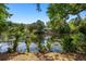 A serene view of the backyard pond surrounded by lush trees, adding a tranquil touch to the property at 2938 Old Drake Dr, Seabrook Island, SC 29455