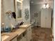 This bathroom features a dual vanity, decorative mirror, toilet, and storage cabinet, creating a calming and functional space at 306 Park St, Saint George, SC 29477