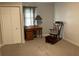 This bedroom features a rocking chair, a desk, a closet, and neutral walls for a relaxing, flexible space at 306 Park St, Saint George, SC 29477
