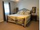 This bedroom features a black metal frame bed, a ceiling fan, and two nightstands with lamps for a comfortable space at 306 Park St, Saint George, SC 29477