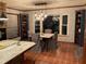 A dining area displays a table with seating, stylish light fixture, built-in shelving, and tile flooring at 306 Park St, Saint George, SC 29477