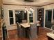 A dining area with tile flooring features a modern light fixture, built-in shelving, and a large window at 306 Park St, Saint George, SC 29477
