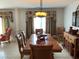 Dining room featuring a wood dining table, decorative lighting, and natural light from the windows at 306 Park St, Saint George, SC 29477