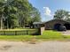 Home exterior showcasing a garage, black picket fence, and a well-kept lawn at 306 Park St, Saint George, SC 29477