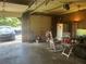View of the garage featuring a vehicle, white refrigerator and rocking chair at 306 Park St, Saint George, SC 29477
