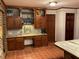 A kitchen features a wood table area, wood cabinets, tile flooring, and neutral countertops at 306 Park St, Saint George, SC 29477