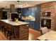 A spacious kitchen shows a brick island with seating, stylish lighting, tile flooring, and blue cabinets at 306 Park St, Saint George, SC 29477