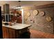 A kitchen featuring a brick island with seating, modern appliances, and a stylish brick wall feature at 306 Park St, Saint George, SC 29477