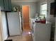 A well-lit laundry room includes storage cabinets, washer and dryer units, and neutral tile flooring at 306 Park St, Saint George, SC 29477