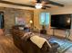 Cozy living room with hardwood floors, leather sofa, and brick wall accents at 306 Park St, Saint George, SC 29477
