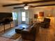 Living room with hardwood floors, leather sofa, recliner, and a bright window at 306 Park St, Saint George, SC 29477