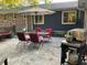 Outdoor patio area features dining set with red cushions and a grill at 306 Park St, Saint George, SC 29477