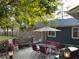 Back patio with outdoor dining set, and a grill at 306 Park St, Saint George, SC 29477