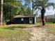 Exterior shot of a shed in the backyard featuring a palm tree at 306 Park St, Saint George, SC 29477
