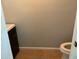 A compact toilet room featuring tile flooring, neutral paint, and simple fixtures at 306 Park St, Saint George, SC 29477