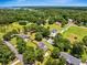 Expansive aerial view of a neighborhood with lush greenery, beautiful homes, and a glimpse of the lake in the background at 309 Pinopolis Park Dr, Moncks Corner, SC 29461