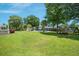 Expansive backyard featuring lush green grass, mature trees and playground equipment at 309 Pinopolis Park Dr, Moncks Corner, SC 29461