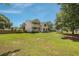 Expansive backyard showcasing a lush green lawn and mature trees at 309 Pinopolis Park Dr, Moncks Corner, SC 29461
