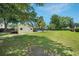 Picturesque backyard featuring an outbuilding, pool, and lush green lawn at 309 Pinopolis Park Dr, Moncks Corner, SC 29461