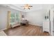 Bright bedroom with hardwood floors, a window seat and a decorative ceiling fan at 309 Pinopolis Park Dr, Moncks Corner, SC 29461