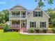 Charming two-story home with a inviting front porch and manicured lawn at 309 Pinopolis Park Dr, Moncks Corner, SC 29461