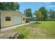 Well-maintained outbuilding near a pool and landscaped yard offers space for hobbies at 309 Pinopolis Park Dr, Moncks Corner, SC 29461