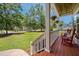 Inviting porch with cozy seating and a view of the expansive, tree-lined yard at 309 Pinopolis Park Dr, Moncks Corner, SC 29461
