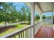 Inviting outdoor porch boasting wooden floors and a serene view of lush greenery at 309 Pinopolis Park Dr, Moncks Corner, SC 29461