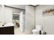 Modern bathroom with dual sinks, sleek cabinetry, and an adjoining shower and toilet area at 313 Marion Rd, Dorchester, SC 29437
